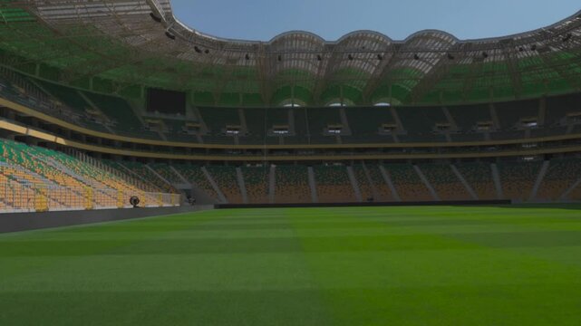 The stadium's green lawn, lush and perfectly mowed for a football match
