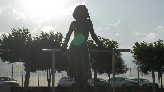 A bronze sculpture of a woman