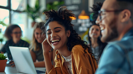 Happy young office colleagues collaborating and smiling in a casual meeting, setting business goals and team building