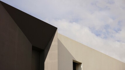 geometric shapes modern facade against the cloudy sky