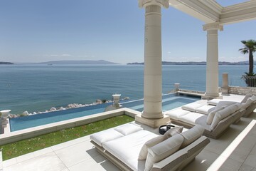 Luxurious seaside terrace with white furniture and ocean view featuring a serene and upscale outdoor setting perfect for relaxation and enjoying the coastal scenery