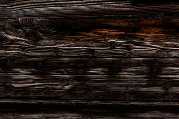 Dark rustic burnt wood background.