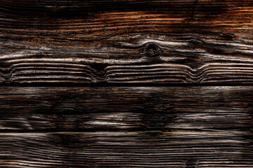 Dark rustic burnt wood background.