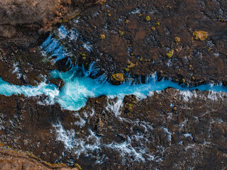 Majestic summer aerial view of Bruarfoss Waterfall. The Icelands Bluest Waterfall. Blue water flows over stones. Midnight sun of Iceland. Visit Iceland. Beauty world.