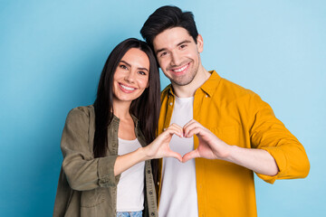 Photo of two nice young partners show heart symbol wear shirt isolated on blue color background