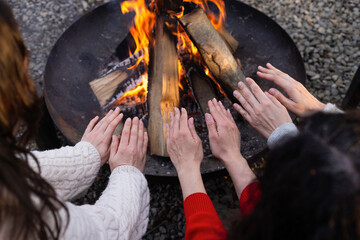 Hands Warmed By Campfire In Winter