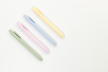 Top view of colorful pens on white background. School, office wallpaper. Flat lay, copy space.