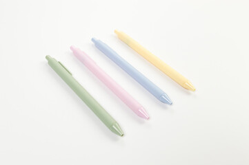Top view of colorful pens on white background. School, office wallpaper. Flat lay, copy space.