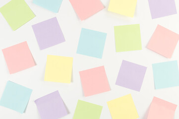 Top view of colorful sticky notes on white background. School, office wallpaper. Flat lay, copy space.