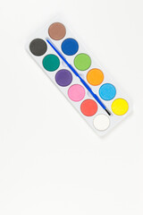 Top view of watercolor and paint brush on white background. Painting, art, copy space, flat lay.