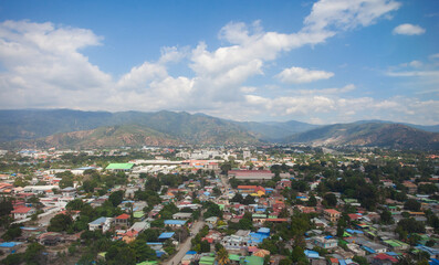 Obraz premium Aerial view of Dili City, the capital of Timor Leste. Urban settlements with a backdrop of hills.