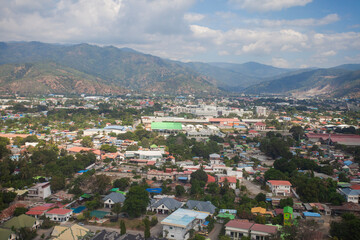 Aerial view of Dili City, the capital of Timor Leste. Urban settlements with a backdrop of hills.