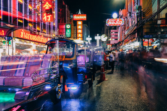 Bangkok, Thailand - July 11, 2019: The light trails from Tuk Tuk, Thai traditional taxi moving on the night of Yaowarat Road at main street in Bangkok's Chinatown.
