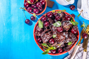 Sweet dessert chocolate dumplings vareniki with cherry berries and chocolate sauce, with sugar powder. Traditional ukrainian, polish, east european pierogi dumplings