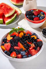 Summer fruit berry salad with tapioca pearls. Healthy diet refreshment salad with watermelon, strawberry, blueberry and bubble tea balls, on white table background copy space