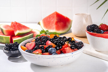 Summer fruit berry salad with tapioca pearls. Healthy diet refreshment salad with watermelon, strawberry, blueberry and bubble tea balls, on white table background copy space