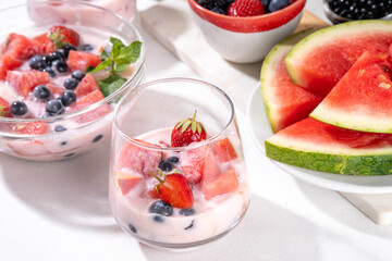 Subak Hwachae cocktail, Korean traditional watermelon punch salad drink, with a lot of fruit slices, with tapioca boba pearls, in glass and bowl for party, copy space