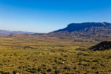 Imposing mountain and green plains in Karoo with green vegetation after winter rains in the Karoo...