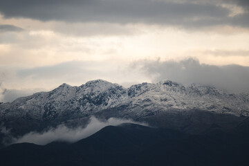 Snow-Capped Mountains Under Cloudy Sky