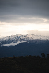 Snow-Capped Mountains Under Cloudy Sky