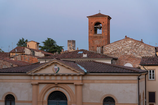 Scenic view of traditional Italian architecture with a bell tower in the background during twilight - Powered by Adobe