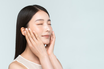Fototapeta premium Skin care. Woman with beauty face touching healthy facial skin portrait. Asian woman. 