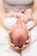 Mother Cradling Crying Newborn in Her Arms