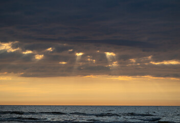 Obraz premium A beautiful sunrise over the Baltic sea - horizon and colorful sky. Natural summer scenery at the Baltic beach in Latvia, Northern Europe.