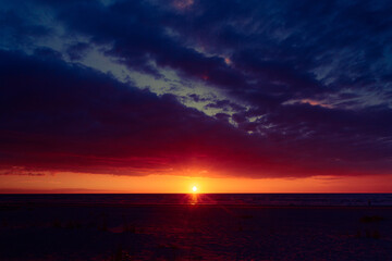 A beautiful sunrise over the Baltic sea - horizon and colorful sky. Natural summer scenery at the Baltic beach in Latvia, Northern Europe.