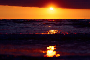 A beautiful sunrise over the Baltic sea - horizon and colorful sky. Natural summer scenery at the Baltic beach in Latvia, Northern Europe.