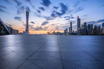 Naklejka premium Empty square floor with modern city buildings scenery at night in Guangzhou. panoramic view. car background.