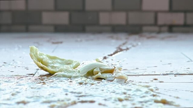 a muskmelon fell to the ground and exploded in slow motion