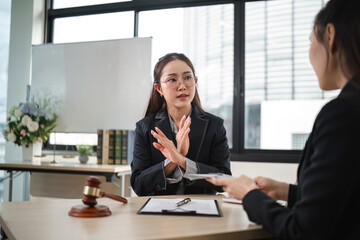 Confident Female Lawyer Denies Corruption Allegations in Modern Office Setting During Client...