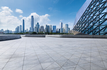 Fototapeta premium Empty square floor with modern city buildings scenery in Guangzhou. car advertising background.