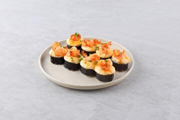 Set of baked sushi roll with shrimp and salmon on a black background. Japanese food, photo for menu