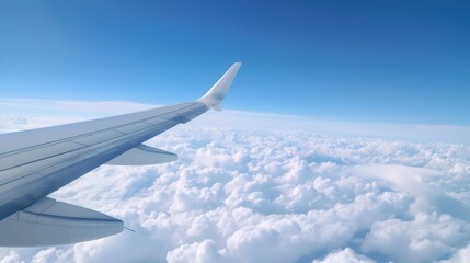 Obraz premium Airplane wing with a view of the clouds, in-flight experience, travel perspective