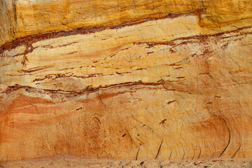 Natural rock texture background of multicolored sandstone rocks in the Almagreira beach in the Peniche area of the Center region of Portugal.