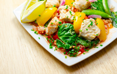 A plate of food with a yellow lemon and green peas