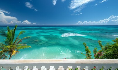 A crystal-clear turquoise ocean with gentle waves, seen from a balcony of a tropical resort