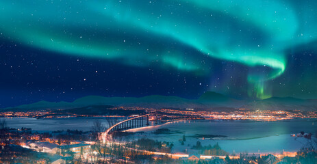 Aurora borealis or Northern lights in the sky over Tromso with Sandnessundet Bridge - Tromso, Norway