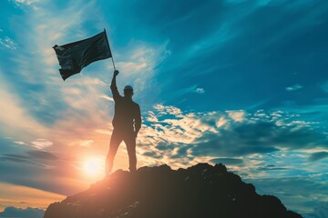 There is a silhouette of a businessman holding a flag on top of a mountain above blue skies and sunshine. The symbolism is one of leadership success and achievement with a clear target and objective.