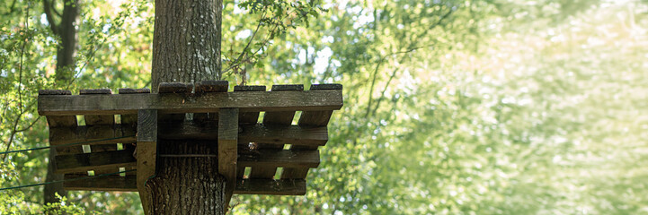 Naklejka premium Adventure bridge, treetop, park, ropes, elements, tree climbing, sport in nature. accrobranche, accrobranches, arborismo.