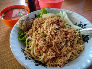 Mie ayam is a typical Indonesian dish made from wheat noodles seasoned with pieces of chicken meat. Chicken noodles are also a popular dish served in small roadside food stalls and large restaurants.