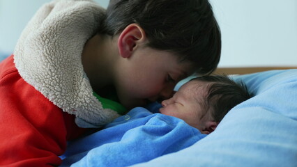 Big brother gently bonding with newborn baby, showcasing love and care in an intimate family moment. Highlights the warmth and connection between siblings