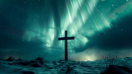 Fototapeta premium Lone wooden cross is standing on a snowy mountain with the northern lights shining brightly in the sky