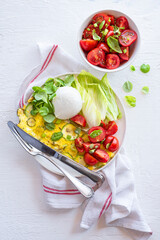 Mozzarella Bufala, omelet with zucchini, salad with tomatoes and basil, assorted lettuce leaves, delicious wonderful summer lunch. A balanced diet with fats, proteins and fiber. Mediterranean diet