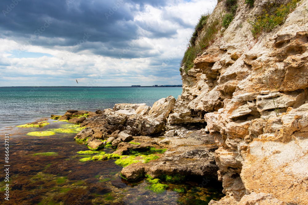 Wall mural scenic rocks under cloudy may sky near the fishing port of ravda, nesebar municipality, burgas provi