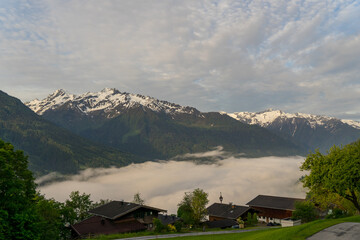 Landscape of valley with fog in the austrian village Bramberg near the mountain Wildkogel