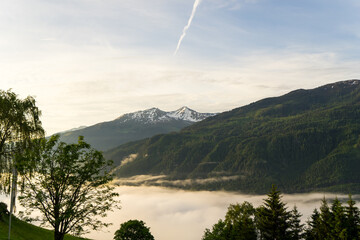 Landscape of valley with fog in the austrian village Bramberg near the mountain Wildkogel