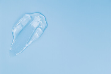Gel smears cosmetic texture on blue background with space for text